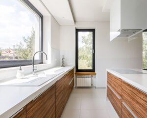 a kitchen with a large window and a sink.
