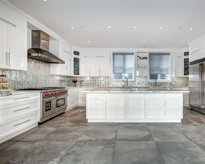 a kitchen with a stove, refrigerator, sink and oven.