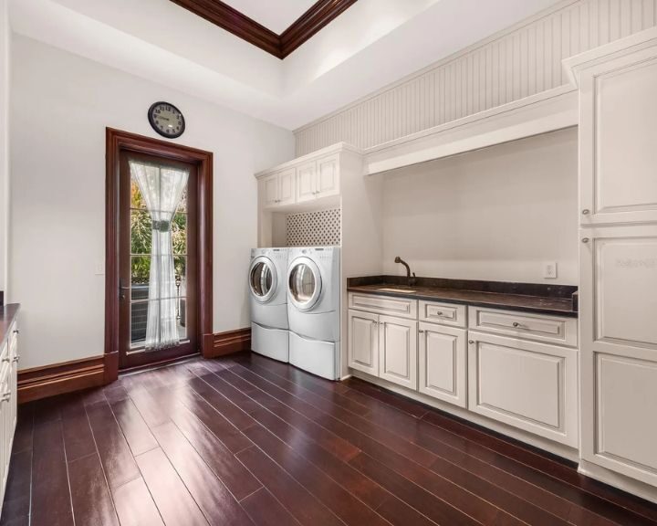 kitchen-cabinets-sarasota-fl-720x576px Spacious laundry room with washer and dryer.