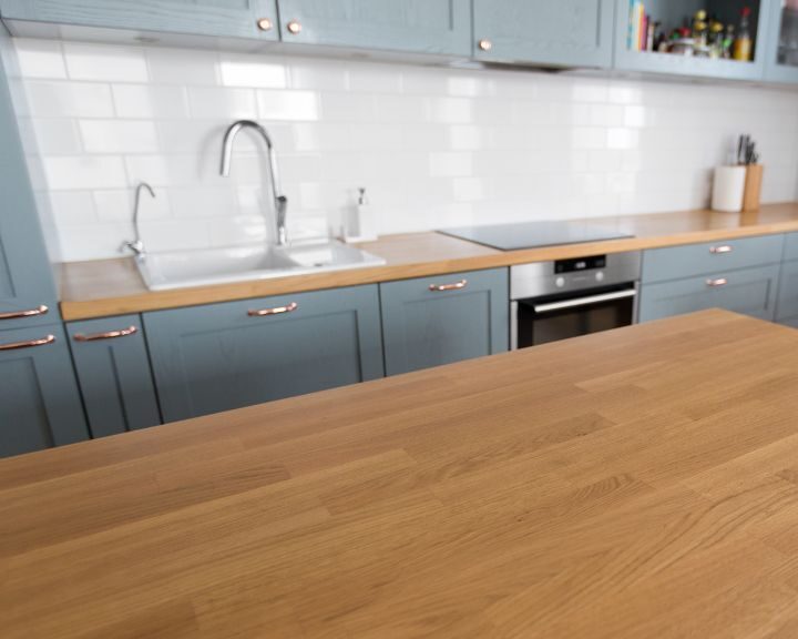 a kitchen with a wooden counter top next to a sink.