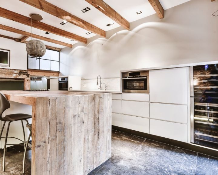 a kitchen with a counter, oven, sink and refrigerator.