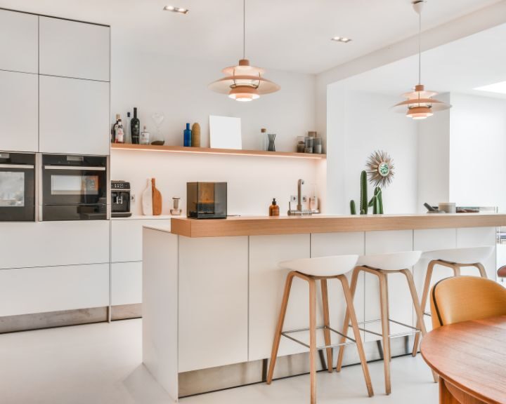 a kitchen with a table, chairs, oven and microwave.