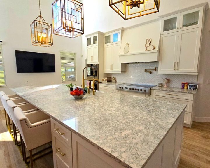 kitchen-refurbishment-sarasota-fl-720x576px Modern kitchen with marble island and pendant lights.