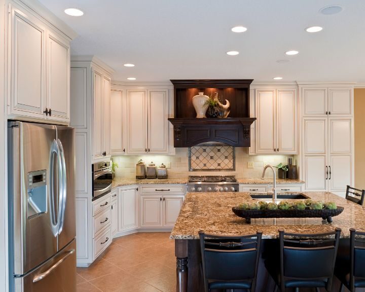 a large kitchen with a center island with chairs.