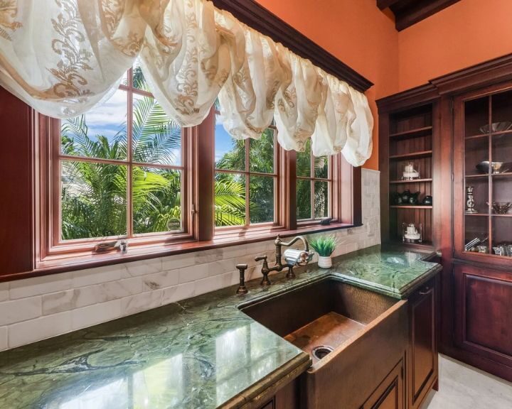 kitchen-tile-sarasota-fl-720x576px Elegant kitchen with green marble countertops and white tiled splashback.