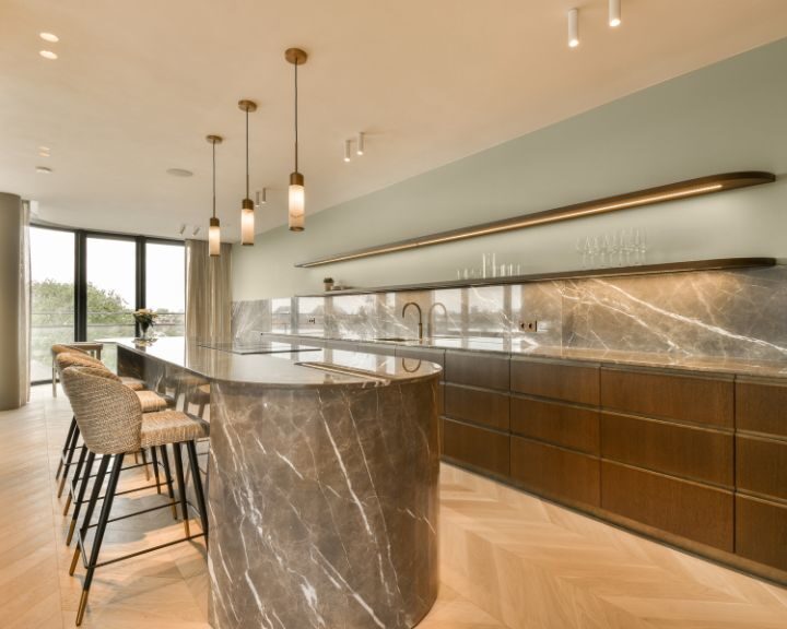 marble-kitchen-countertops-sarasota-fl-720x576px Modern kitchen with marble island and pendant lights.